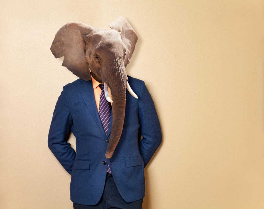 a man with suit and with elephant head